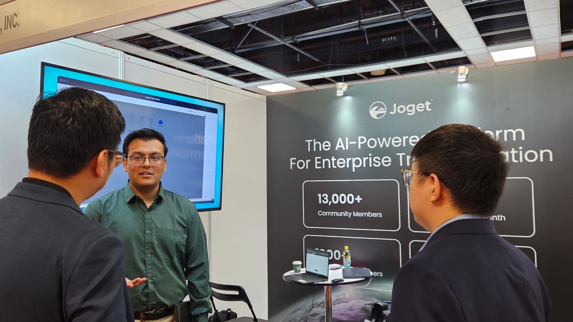 Anchit Shrivastava presenting Joget's AI-powered enterprise platform at a booth beneath a banner reading 'The AI-Powered Platform For Enterprise Transformation'.