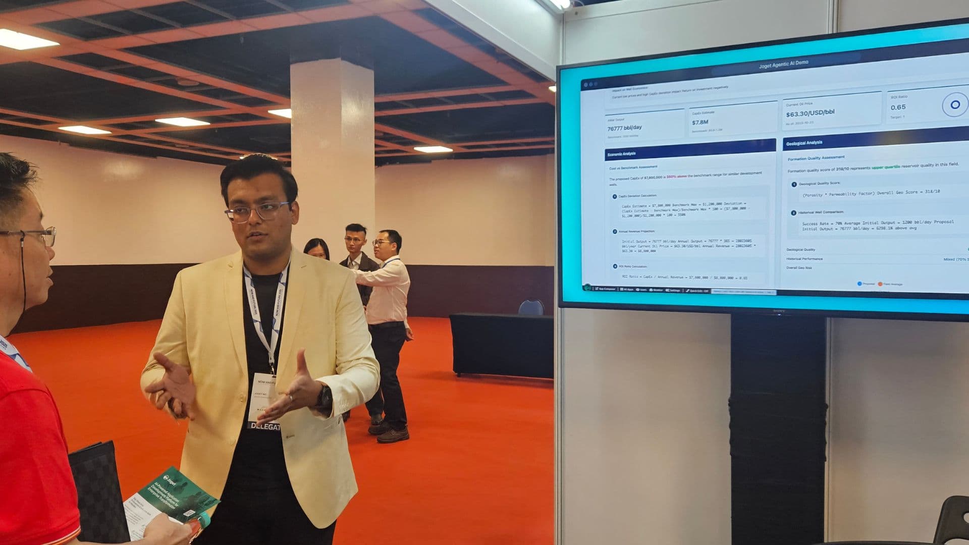 Anchit Shrivastava presenting beside a large screen displaying a 'Joget Agentic AI Demo' dashboard.